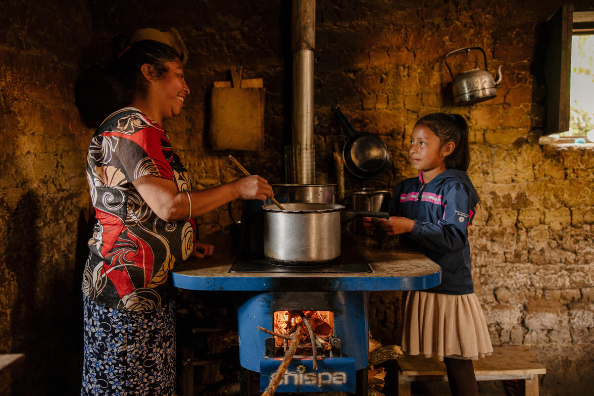 A mother cooking with her daughter