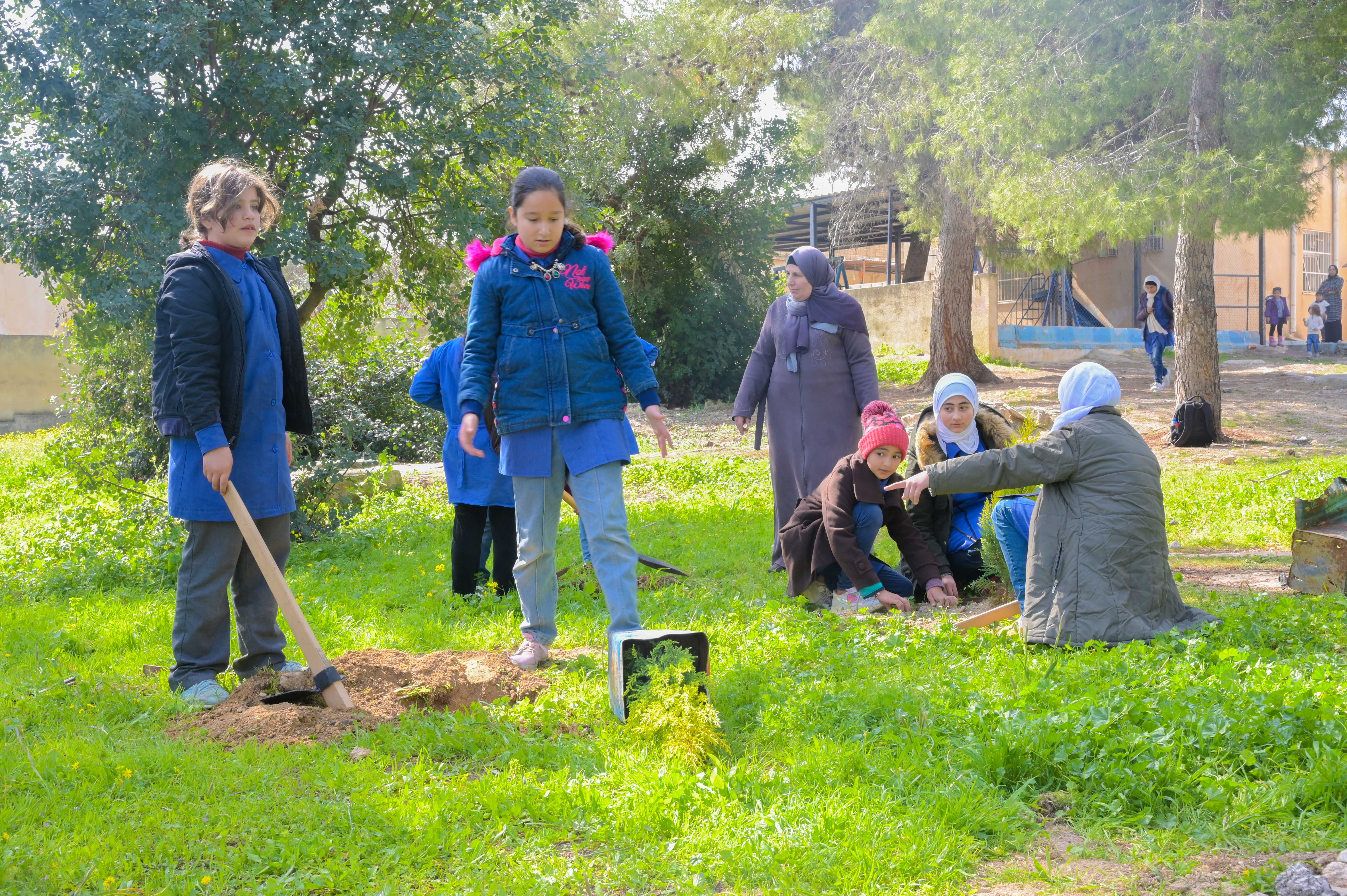 Students planting trees that will be irrigated by the grey water system in the school in Jordan.