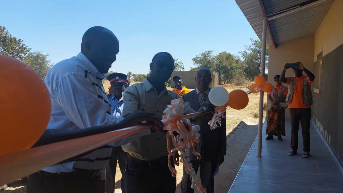 The Board chairperson Malcolm Chabala cuts the ribbon with the help of Pemba district commissioner at the handover of the boarding facility.