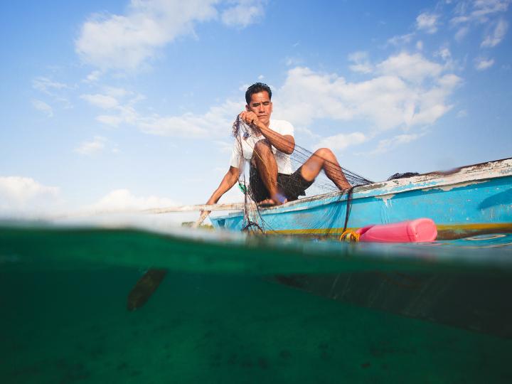 A fisherman in the Philippines uses a microloan to fund his small business
