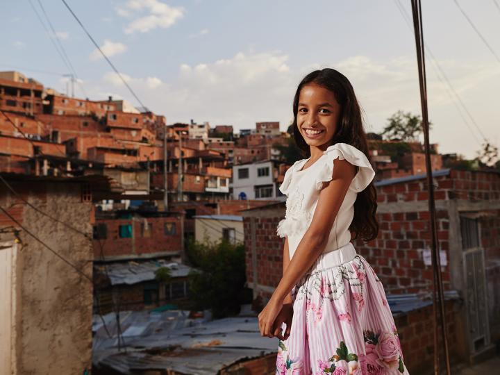 A Colombian girl stands in her village