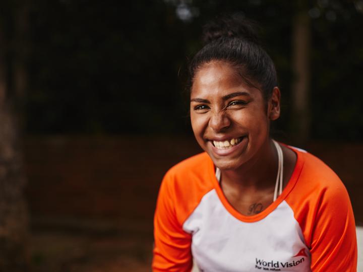 A World Vision Colombia employee smiles at a park