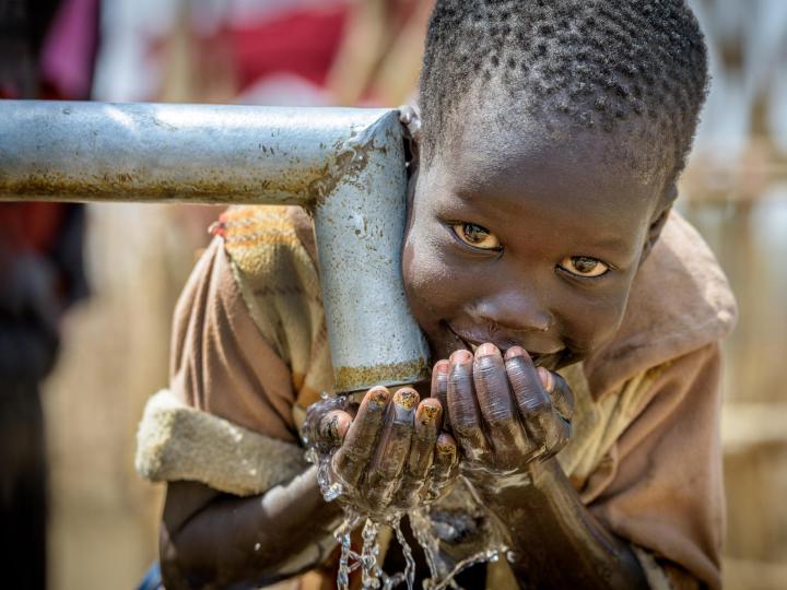 A Sudanese boy drinking clean water