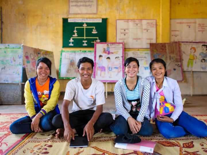 Khmer youth sit on the floor of their community space, Cambodia