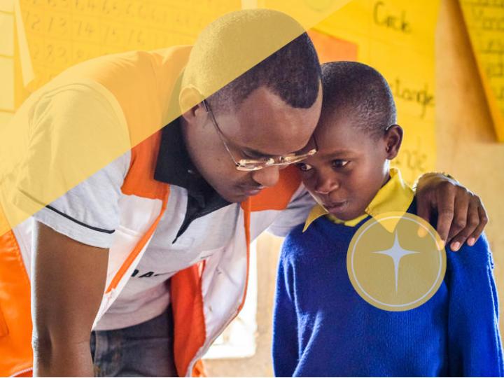 Faith and development, world vision staff speak with child