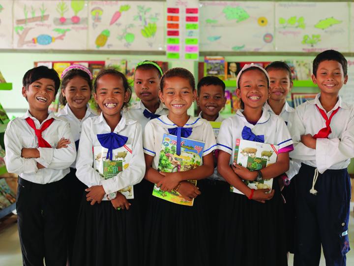 children standing in school with books