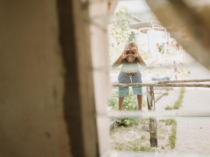 Child looking through window