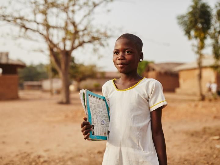 Girl with school book in Africa
