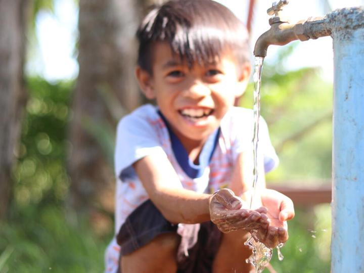 child washing his hands