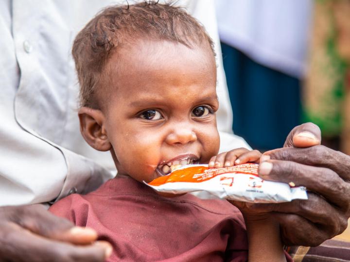 small child eats nutritional supplement 