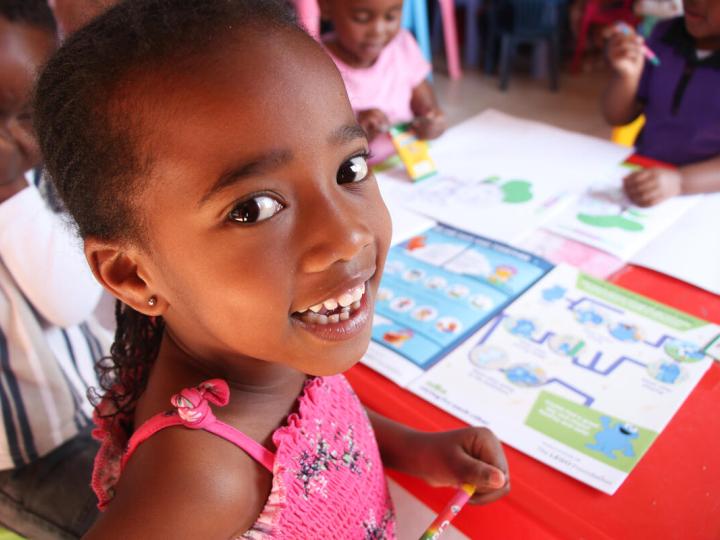Ihlali and her drawing book which was funded by the Lego Foundation