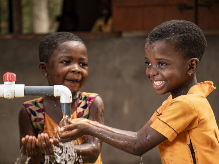 Two girls enjoying access to clean water