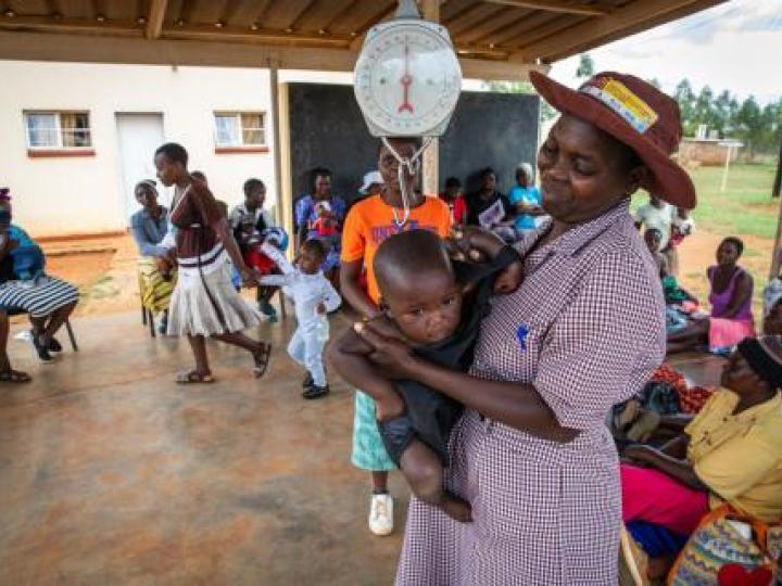 Gertrude CHW Zim Weighing baby