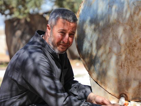 Samer* filling water from the water tank.